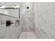 Modern shower with elegant marble tiling, a built-in niche, and black fixtures at 11842 Richmond Trl, Parrish, FL 34219