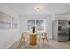 Bright dining area featuring a round table, stainless steel appliances, and modern fixtures at 11860 129Th Ave, Largo, FL 33778