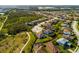 Stunning aerial view of single Gathering homes with sidewalks, greenery, and a large wooded area at 12031 Medley Ter, Lakewood Ranch, FL 34211