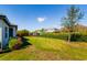 Spacious backyard with lush lawn and mature landscaping and swingset at 12031 Medley Ter, Lakewood Ranch, FL 34211