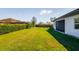 Backyard features green lawn, privacy hedge and covered lanai at 12031 Medley Ter, Lakewood Ranch, FL 34211