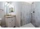 Bathroom featuring granite countertops, a vanity with storage, and tiled shower at 12031 Medley Ter, Lakewood Ranch, FL 34211