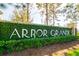 The community sign says Arbor Grande and is surrounded by a lush green wall of landscaping at 12031 Medley Ter, Lakewood Ranch, FL 34211