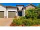 Charming single-story home featuring a stone facade, manicured landscaping, and a welcoming front entrance at 12031 Medley Ter, Lakewood Ranch, FL 34211