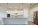 Bright kitchen featuring white cabinets, granite countertops, stainless steel appliances, and modern pendant lighting at 12031 Medley Ter, Lakewood Ranch, FL 34211