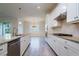 Bright kitchen with white cabinets, stainless steel appliances, granite countertops, and tile flooring at 12031 Medley Ter, Lakewood Ranch, FL 34211