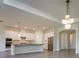Spacious kitchen featuring white cabinetry, granite counters, stainless steel appliances, and modern pendant lighting at 12031 Medley Ter, Lakewood Ranch, FL 34211