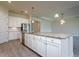 Open kitchen with white cabinets, stainless steel appliances, granite countertops, and tile flooring at 12031 Medley Ter, Lakewood Ranch, FL 34211