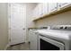 Well-equipped laundry room with full-size washer and dryer, plus extra overhead cabinets at 12031 Medley Ter, Lakewood Ranch, FL 34211