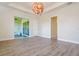 Open living room with wood-look tile flooring and access to patio at 12031 Medley Ter, Lakewood Ranch, FL 34211