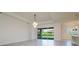 Spacious living room featuring neutral walls, large sliding glass doors, and tile flooring with natural light at 12031 Medley Ter, Lakewood Ranch, FL 34211