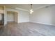 Spacious living room with wood-look tile flooring and modern lighting at 12031 Medley Ter, Lakewood Ranch, FL 34211