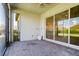 Screened-in patio with brick flooring and large sliding glass doors to the interior at 12031 Medley Ter, Lakewood Ranch, FL 34211