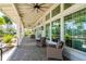 Inviting porch with large windows, stylish wicker chairs and ceiling fans, perfect for relaxing and enjoying fresh air at 12031 Medley Ter, Lakewood Ranch, FL 34211