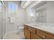 Bathroom featuring a glass-enclosed shower and a large vanity with brown cabinets at 1227 Darlington Oak Ne Cir, St Petersburg, FL 33703