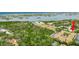 A high-angle aerial view of the property complex surrounded by lush trees and a large body of water at 12760 Indian Rocks Rd # 532, Largo, FL 33774