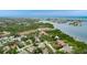 Stunning aerial view showcasing the coastal neighborhood near water, lush trees, and community buildings at 12760 Indian Rocks Rd # 532, Largo, FL 33774
