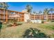 Community backyard featuring lush green lawn and picnic table with umbrella, surrounded by tropical landscaping at 12760 Indian Rocks Rd # 532, Largo, FL 33774