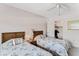 Comfortable bedroom featuring twin beds, a closet, and a ceiling fan at 12760 Indian Rocks Rd # 532, Largo, FL 33774