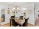 Dining area featuring a marble-top table, chandelier, and black leather chairs at 12760 Indian Rocks Rd # 532, Largo, FL 33774