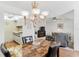 Dining area featuring a marble-top table, chandelier, and views of the living room and kitchen at 12760 Indian Rocks Rd # 532, Largo, FL 33774