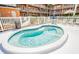Inviting, kidney-shaped hot tub enclosed by a white fence, perfect for relaxation in a landscaped backyard at 12760 Indian Rocks Rd # 532, Largo, FL 33774
