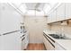 Functional kitchen with white appliances, bright lighting, and ample counter space at 12760 Indian Rocks Rd # 532, Largo, FL 33774