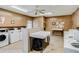 On-site laundry room featuring multiple washers and dryers with ceiling fan at 12760 Indian Rocks Rd # 532, Largo, FL 33774
