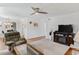 Comfortable living room featuring a ceiling fan and an entertainment center with a fireplace at 12760 Indian Rocks Rd # 532, Largo, FL 33774