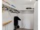 View of a storage room featuring shelving, hanging rack with hangers, and a black rolling cart at 12760 Indian Rocks Rd # 532, Largo, FL 33774