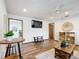 Living room with hard floors, ceiling fan, television, and access to other rooms of the home at 13148 Huntington Woods Ave, Spring Hill, FL 34609