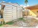 Exterior view of metal shed with a fenced yard at 13148 Huntington Woods Ave, Spring Hill, FL 34609