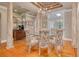 Elegant dining room showcasing hardwood floors, decorative columns, and a stylish chandelier at 1354 Sturbridge Ct, Dunedin, FL 34698