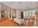 Open-concept living room featuring hardwood floors, decorative pillars, and neutral furniture at 1354 Sturbridge Ct, Dunedin, FL 34698