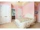 Charming bedroom with an adjacent bathroom, closet, and bright wall paint at 1409 Hillside Landing Dr, Tarpon Springs, FL 34688