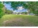 Large backyard with plenty of room for outdoor activities, featuring a well-maintained lawn and mature trees at 1700 S Miller Rd, Valrico, FL 33594