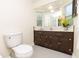 Bathroom features dark wood vanity, ample lighting, and tiled floors at 1700 S Miller Rd, Valrico, FL 33594