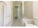 Bathroom showcases white floors and a glass-enclosed shower and tub at 1700 S Miller Rd, Valrico, FL 33594