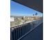 Balcony view showcasing parking, nearby building, and waterfront in the distance on a bright sunny day at 1868 Shore S Dr # 608, South Pasadena, FL 33707