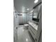 Stylish bathroom with modern vanity, tiled shower with glass block, and ample lighting at 1868 Shore S Dr # 608, South Pasadena, FL 33707
