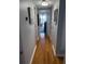 Inviting hallway with wooden floors and neutral paint, leading to a bright living space with water views at 1868 Shore S Dr # 608, South Pasadena, FL 33707