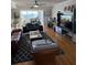 Cozy living room with hardwood floors, comfortable seating, and a view of the water at 1868 Shore S Dr # 608, South Pasadena, FL 33707