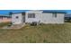 The property's air conditioning unit is placed in the backyard for efficient cooling and space optimization at 196 Philadelphia Blvd # 10, Palm Harbor, FL 34684