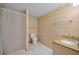 Simple bathroom featuring a toilet, shower with curtain, and vanity with storage at 196 Philadelphia Blvd # 10, Palm Harbor, FL 34684