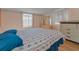 Comfortable bedroom with a floral bedspread and natural light from the windows at 196 Philadelphia Blvd # 10, Palm Harbor, FL 34684
