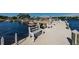 Community dock area with multiple boat slips and benches for relaxing by the water at 196 Philadelphia Blvd # 10, Palm Harbor, FL 34684