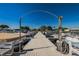 Community dock with multiple boat slips and overhead lighting for easy evening access at 196 Philadelphia Blvd # 10, Palm Harbor, FL 34684