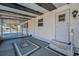A covered entrance area with a painted cement floor and a screened-in enclosure for a comfortable transition at 196 Philadelphia Blvd # 10, Palm Harbor, FL 34684