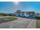 Well-maintained single-story home with covered parking, ramp access, and a decorative front bench at 196 Philadelphia Blvd # 10, Palm Harbor, FL 34684