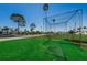 Golf practice cage set on artificial turf; perfect for honing your golf game outdoors at 196 Philadelphia Blvd # 10, Palm Harbor, FL 34684